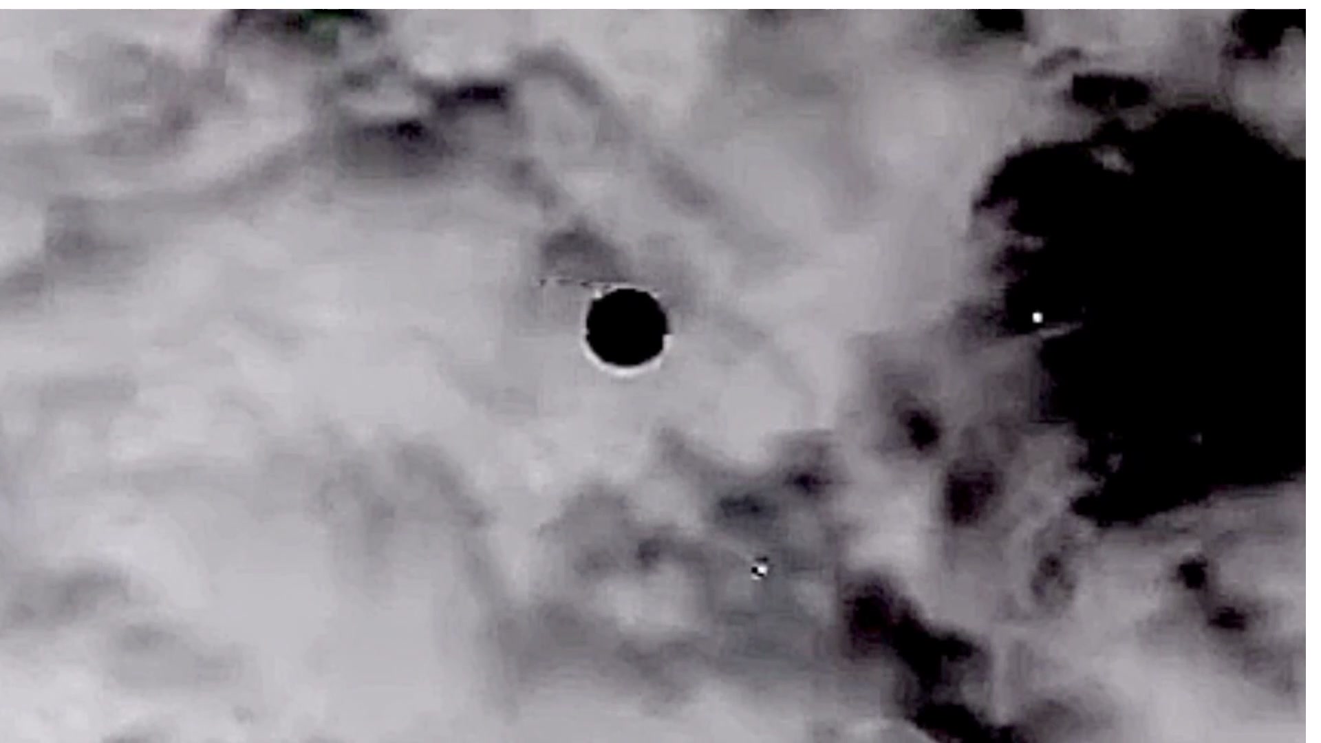 PR055 IR frame showing disc-shaped UAP against clouds over Afghanistan